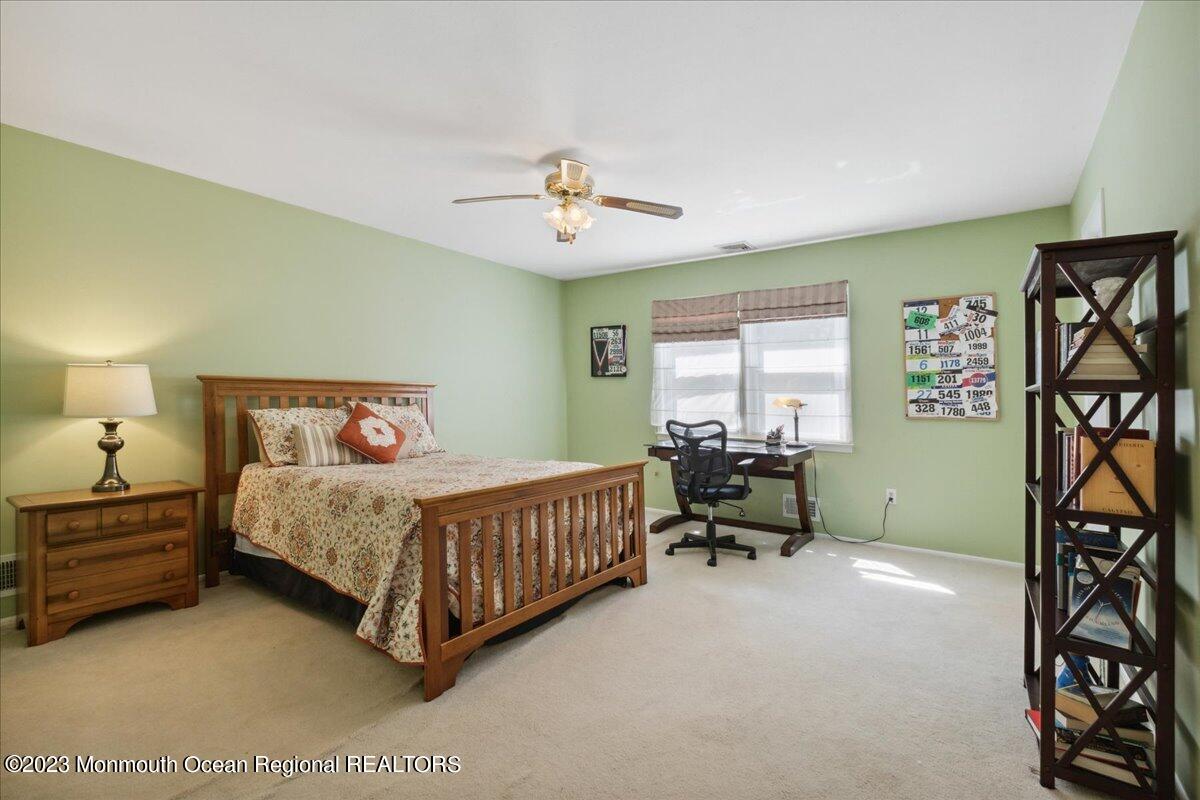 136 Lancaster Road Freehold, NJ 07728 - Photo 26 of 44 a bedroom with a bed and a chandelier