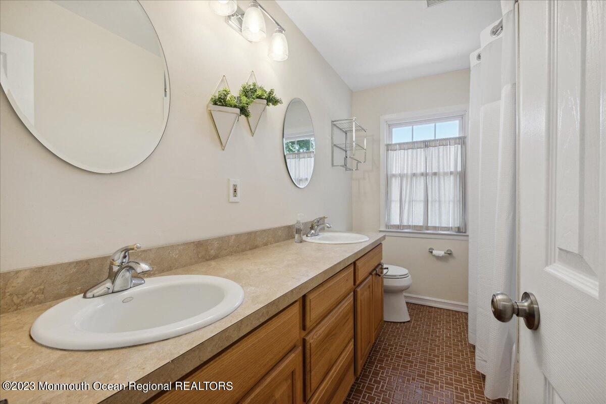 136 Lancaster Road Freehold, NJ 07728 - Photo 29 of 44 a bathroom with a granite countertop sink and a mirror