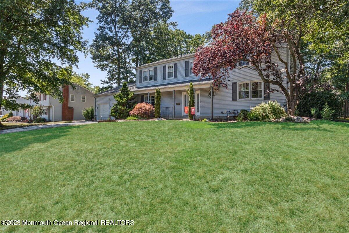 136 Lancaster Road Freehold, NJ 07728 - Photo 3 of 44 a view of a house with a big yard and large trees