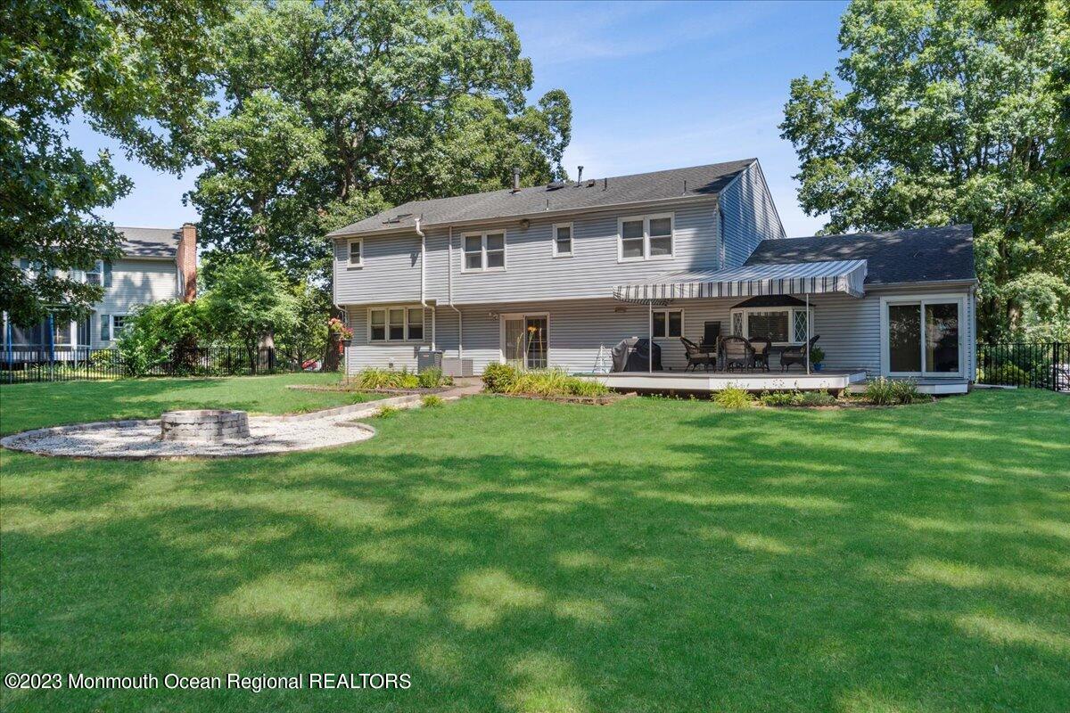 136 Lancaster Road Freehold, NJ 07728 - Photo 32 of 44 a front view of a house with a yard table and chairs