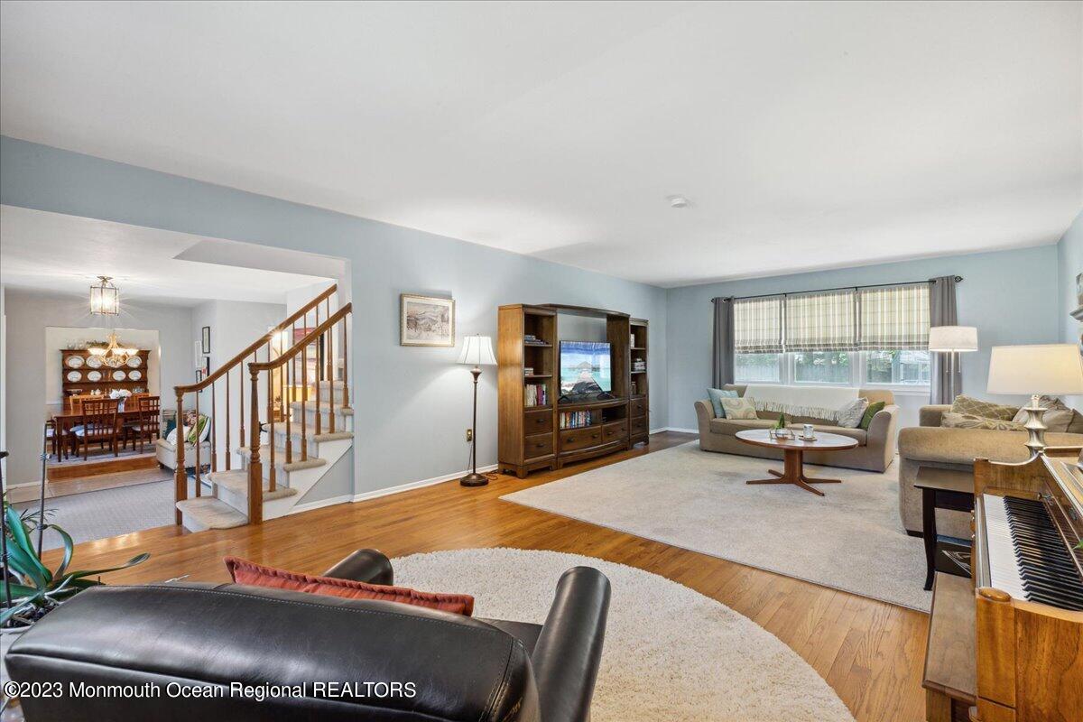 136 Lancaster Road Freehold, NJ 07728 - Photo 7 of 44 a living room with furniture a flat screen tv and a large window