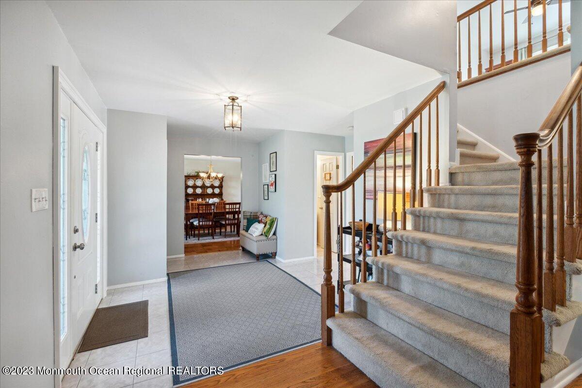 136 Lancaster Road Freehold, NJ 07728 - Photo 9 of 44 a view of an entryway with wooden floor and a livingroom view