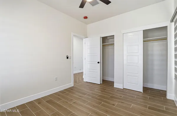 a view of an empty room with wooden floor