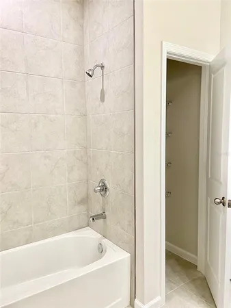a white bath tub sitting next to a shower