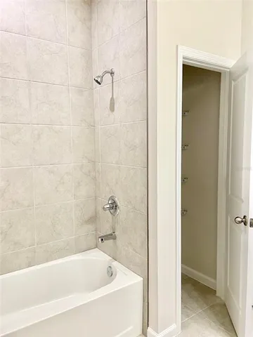 a white bath tub sitting next to a shower