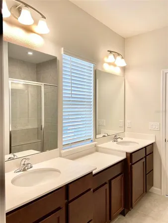 a bathroom with a sink double vanity and a mirror