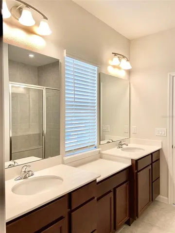 a bathroom with a sink double vanity and a mirror