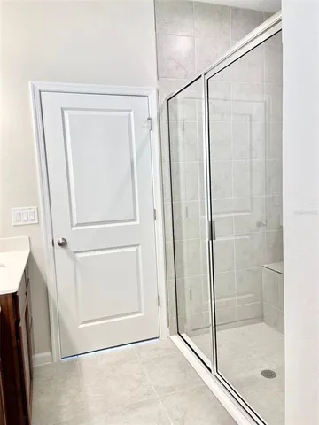 a bathroom with a glass shower door