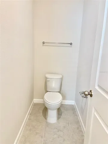 a white toilet sitting in a bathroom