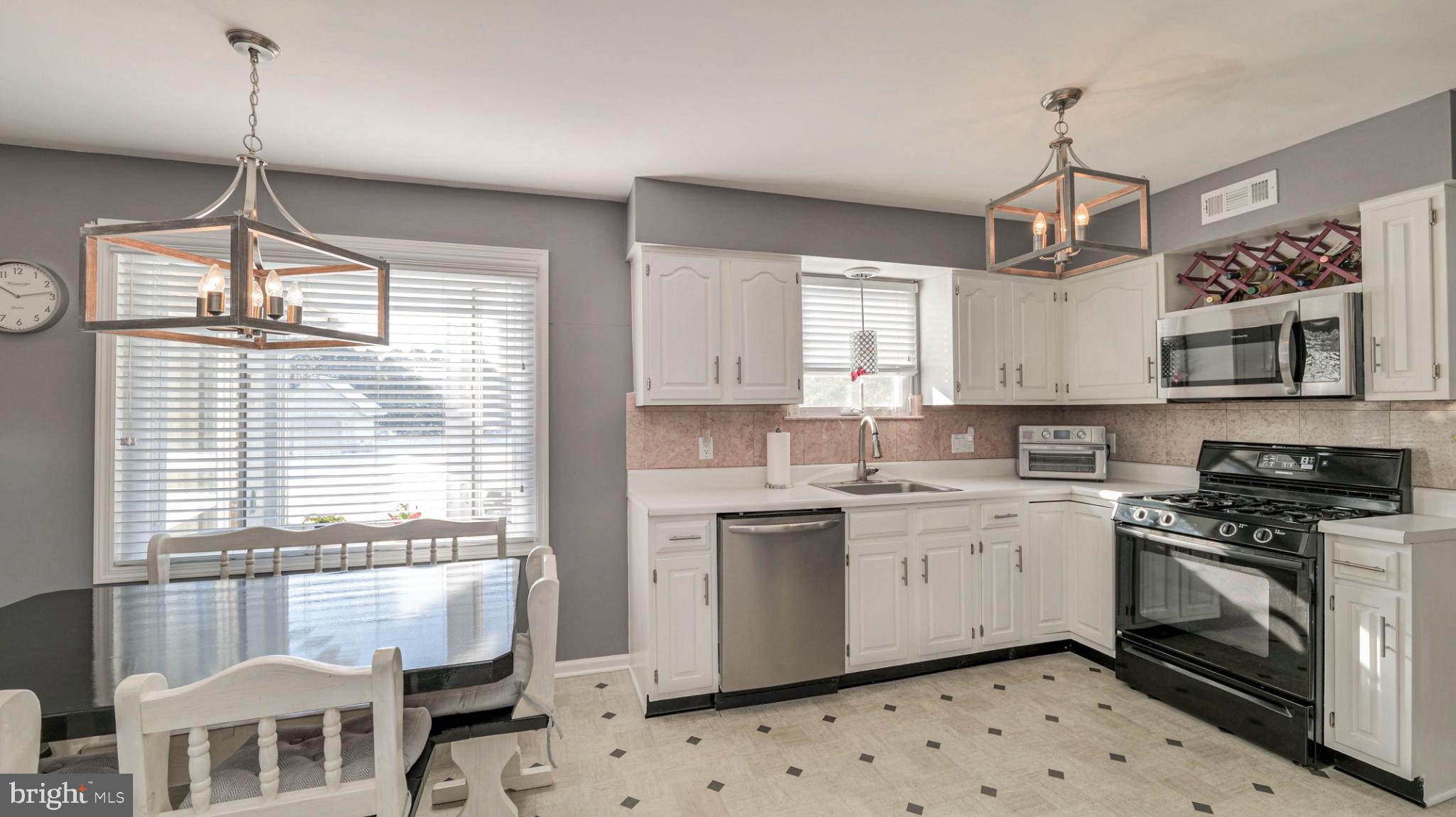 68 Wayside Road Berlin, NJ 08009 - Photo 12 of 31 a kitchen with stainless steel appliances granite countertop a stove a sink dishwasher a refrigerator and a window