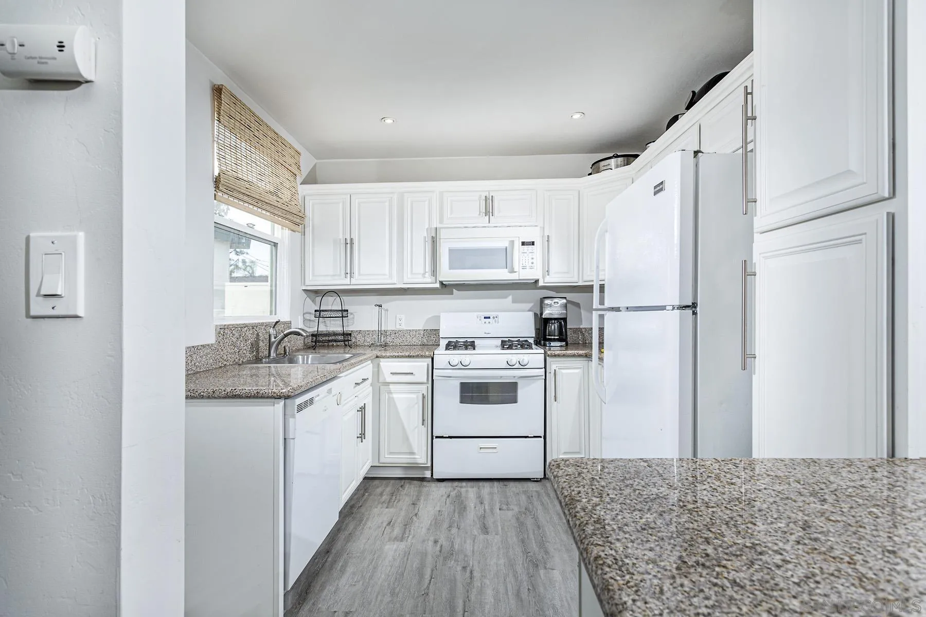 804 Vanderbilt Place San Diego, CA 92103 - Photo 12 of 18 a kitchen with white cabinets and white appliances
