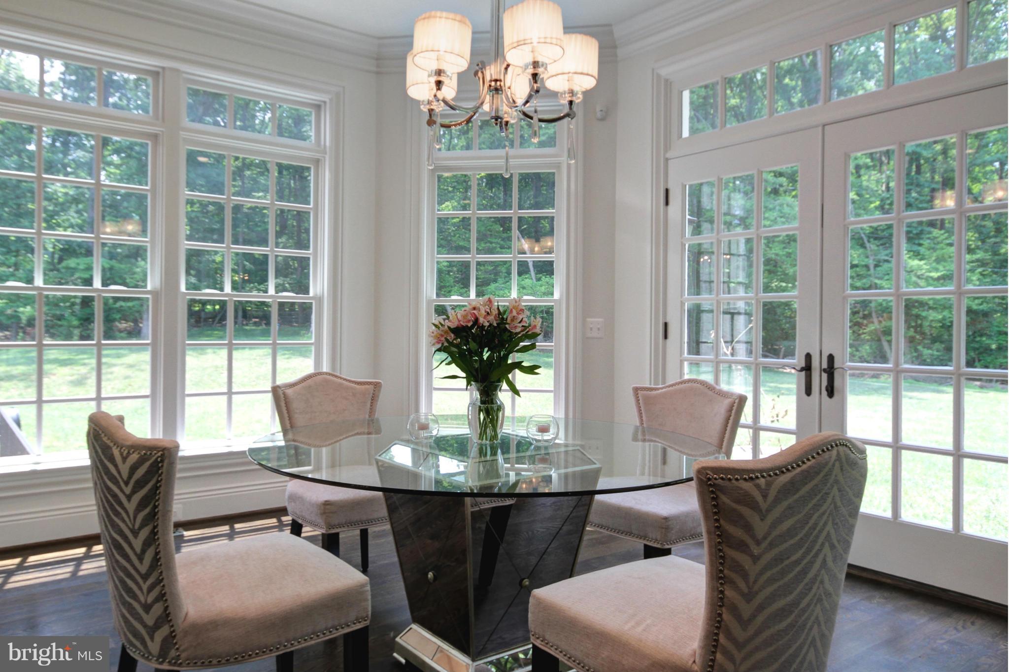448 Springvale Road Great Falls, VA 22066 - Photo 12 of 30 a view of a dining room with furniture a chandelier and wooden floor