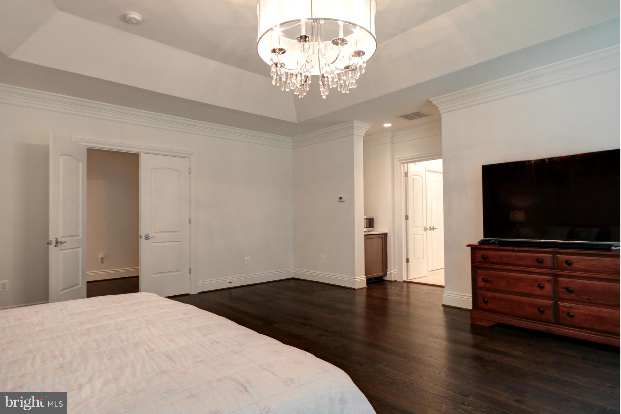 448 Springvale Road Great Falls, VA 22066 - Photo 20 of 30 a bedroom with wooden floor and flat screen tv