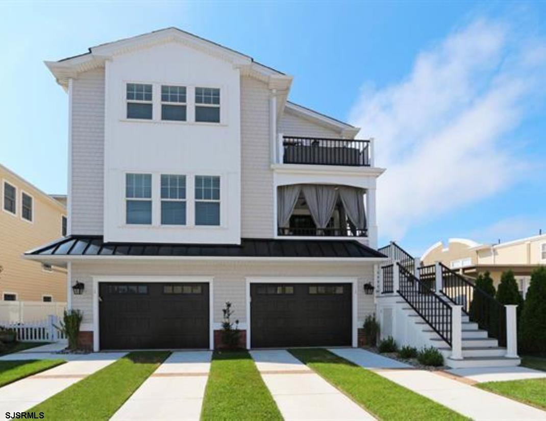 a front view of a building with a garden
