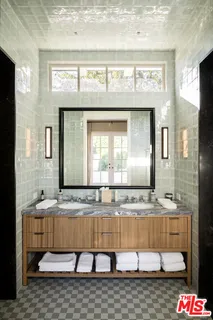 a bathroom with mirror sink and bathtub