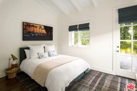 a bedroom with bed and a window
