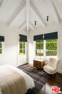 a spacious bedroom with a bed and a large window