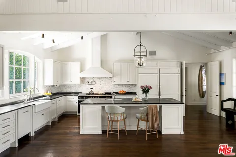a kitchen with stainless steel appliances granite countertop a sink and cabinets