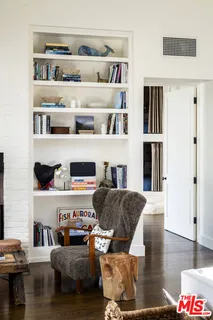 a living room with furniture and a book shelf