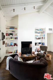 a bedroom with furniture and a flat screen tv