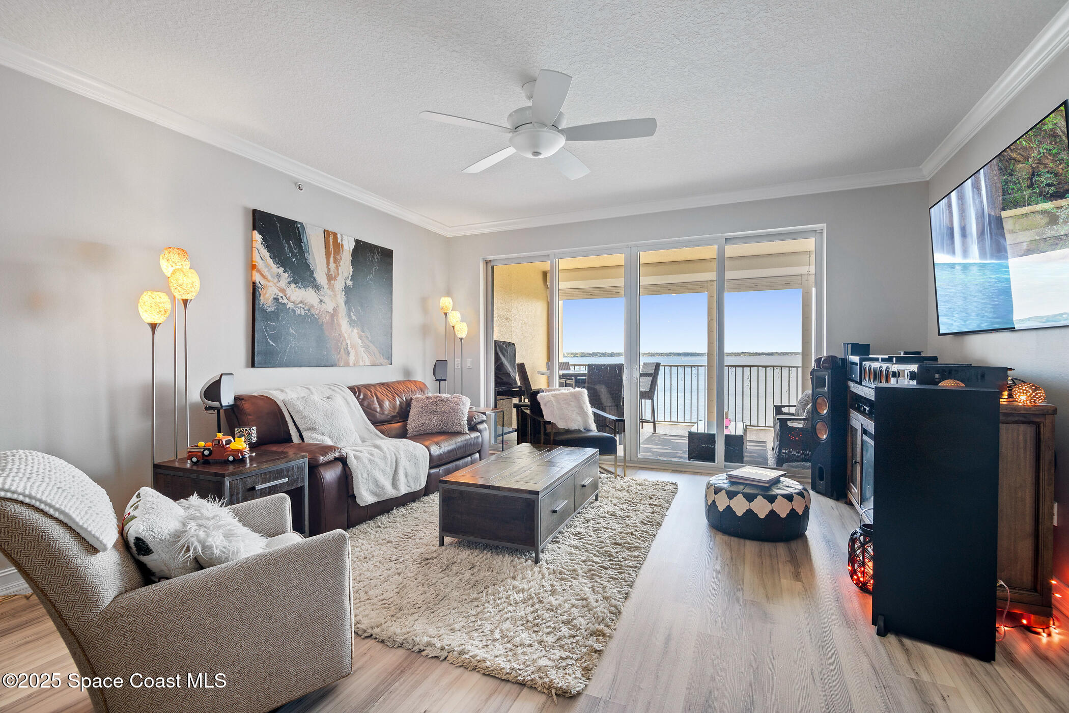 480 Sail Lane, Unit 703 Merritt Island, FL 32953 - Photo 13 of 41 a living room with furniture and a large window