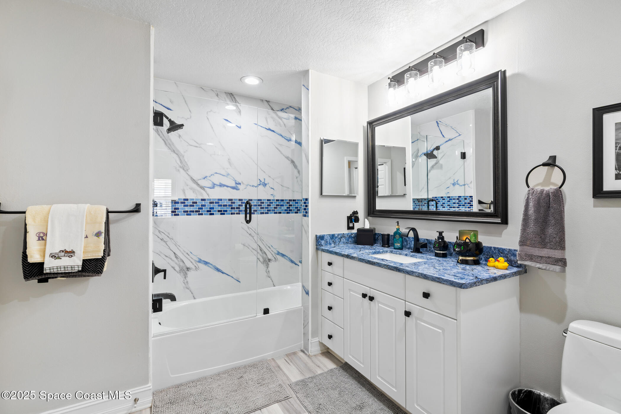 480 Sail Lane, Unit 703 Merritt Island, FL 32953 - Photo 25 of 41 a bathroom with a tub sink and mirror