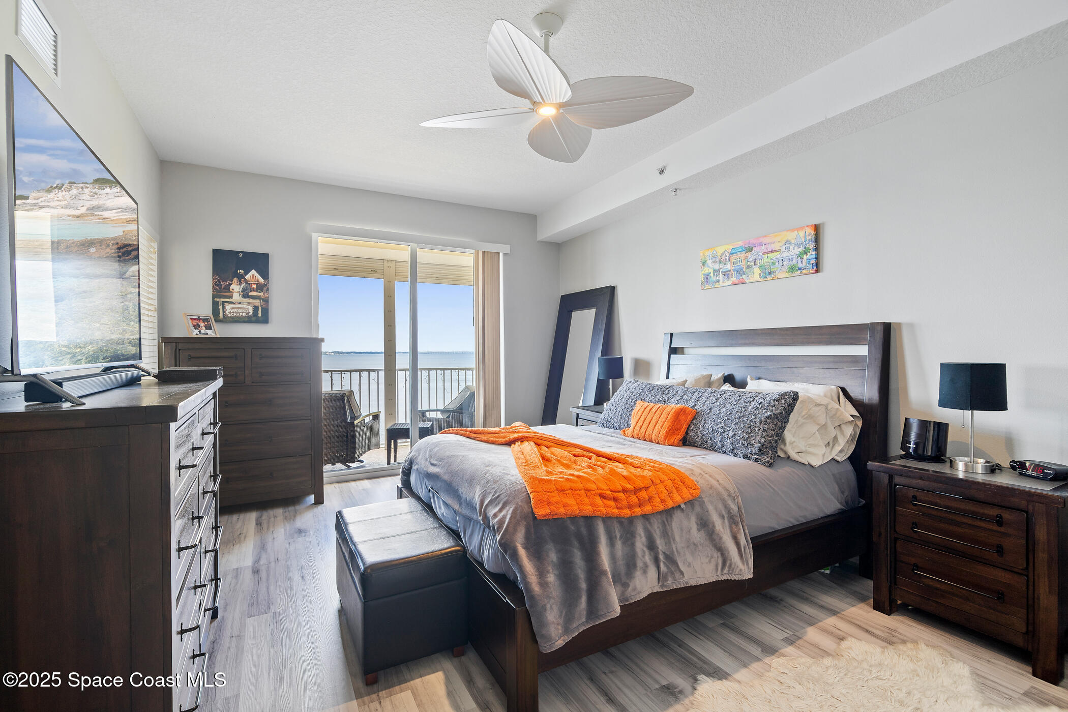 480 Sail Lane, Unit 703 Merritt Island, FL 32953 - Photo 26 of 41 a bedroom with a bed and wooden floor