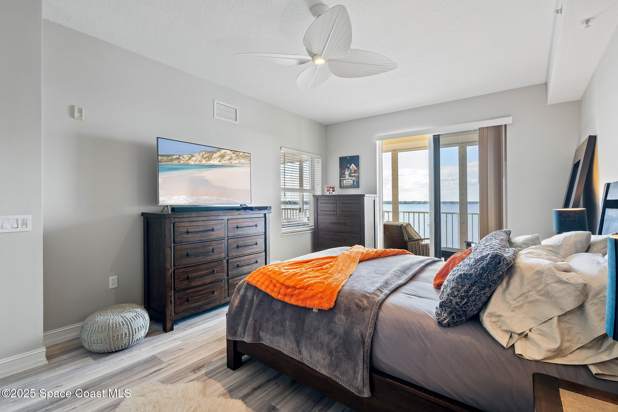 480 Sail Lane, Unit 703 Merritt Island, FL 32953 - Photo 27 of 41 a bedroom with a bed and wooden floor