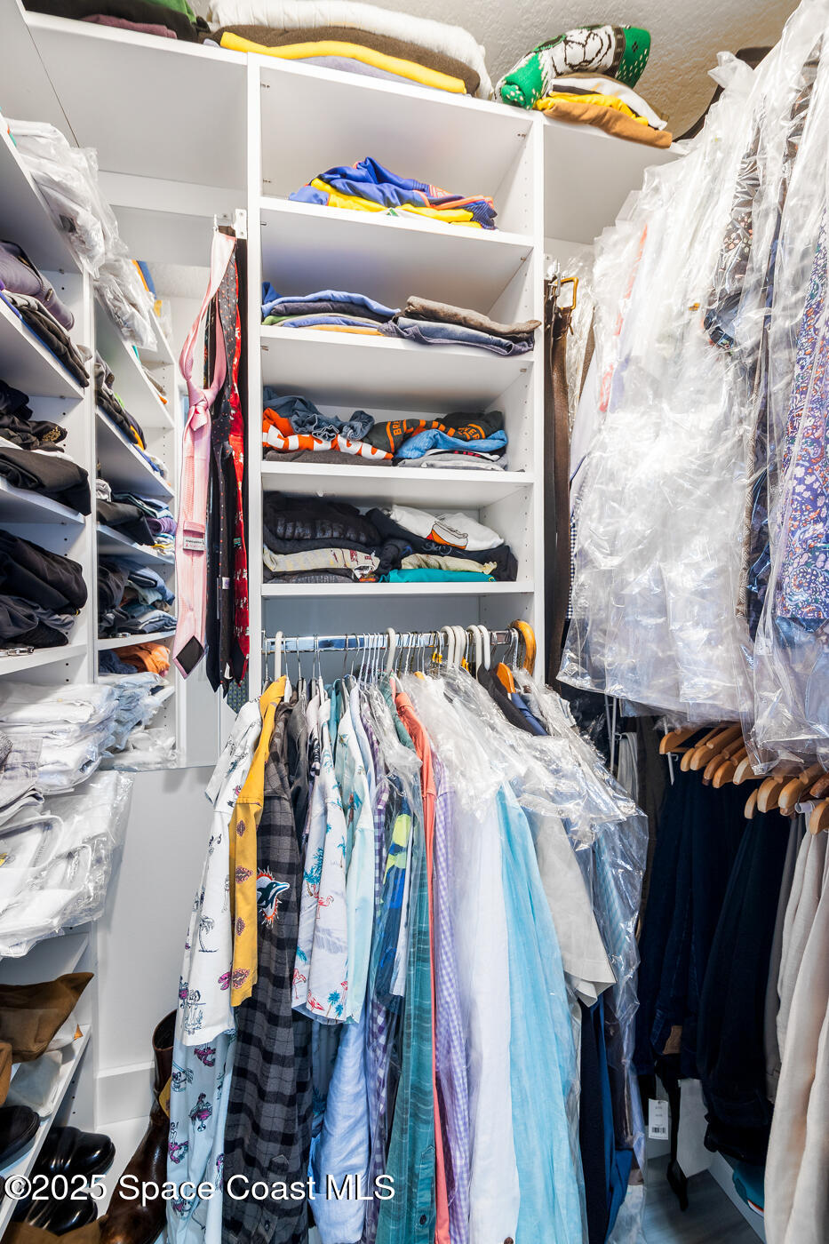 480 Sail Lane, Unit 703 Merritt Island, FL 32953 - Photo 28 of 41 a view of walk in closet with clothes and shoes