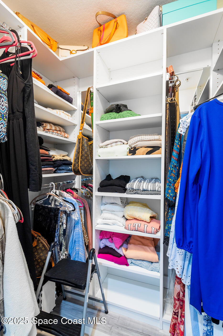 480 Sail Lane, Unit 703 Merritt Island, FL 32953 - Photo 29 of 41 a view of walk in closet with clothes and shoes