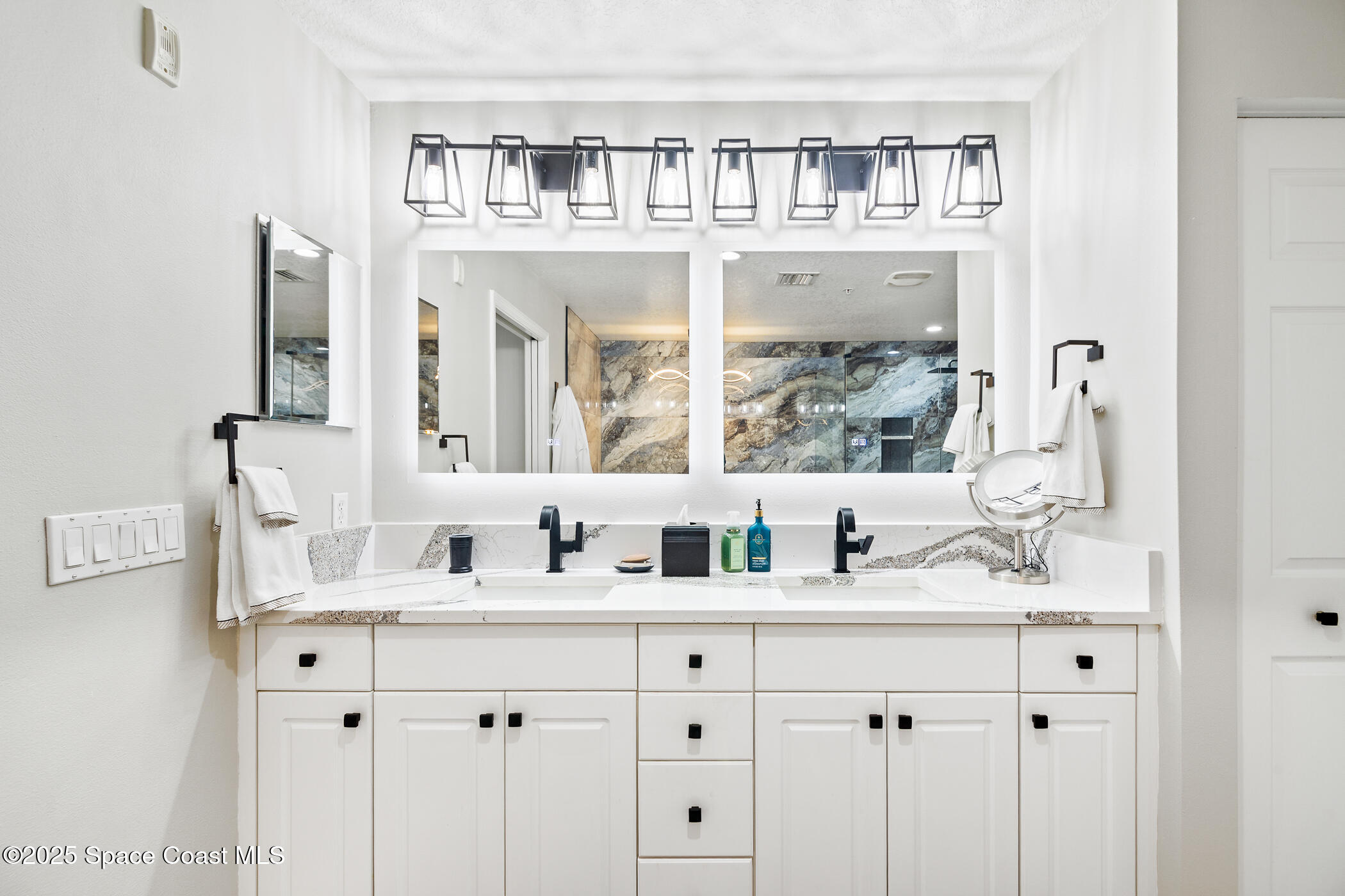 480 Sail Lane, Unit 703 Merritt Island, FL 32953 - Photo 30 of 41 a bathroom with double vanity sinks and a mirror