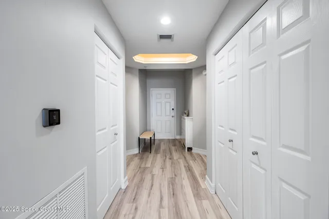 a kitchen with a refrigerator stove and white cabinets