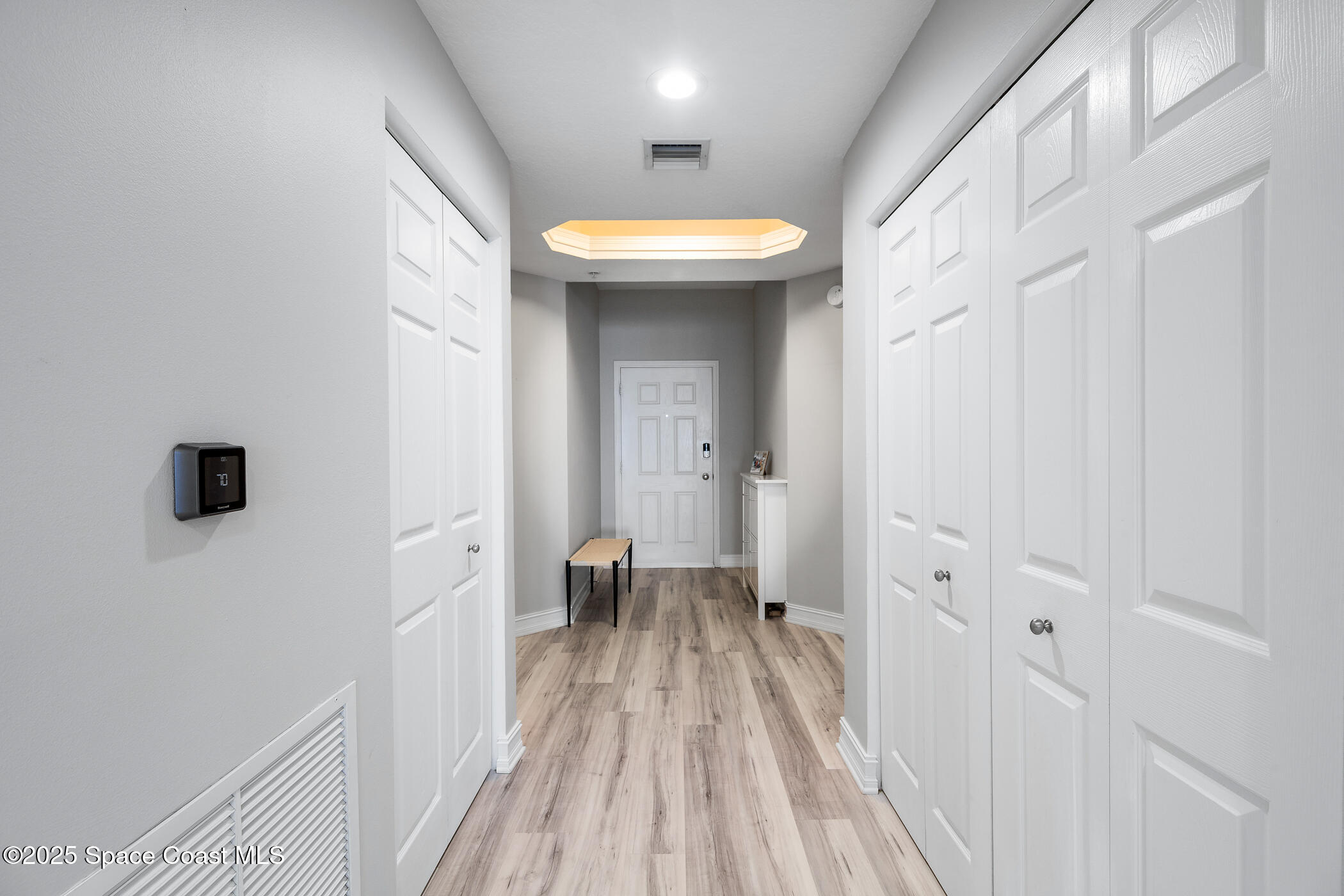 480 Sail Lane, Unit 703 Merritt Island, FL 32953 - Photo 3 of 41 a view of a room with wooden floor and a bathroom