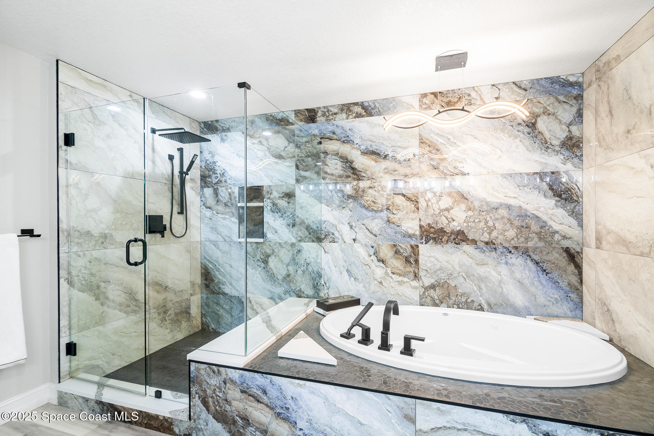 480 Sail Lane, Unit 703 Merritt Island, FL 32953 - Photo 31 of 41 a bathroom with a tub and a sink