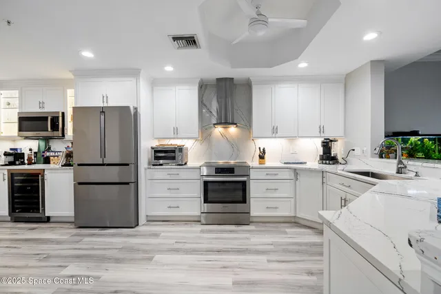 a kitchen with a refrigerator and a stove top oven