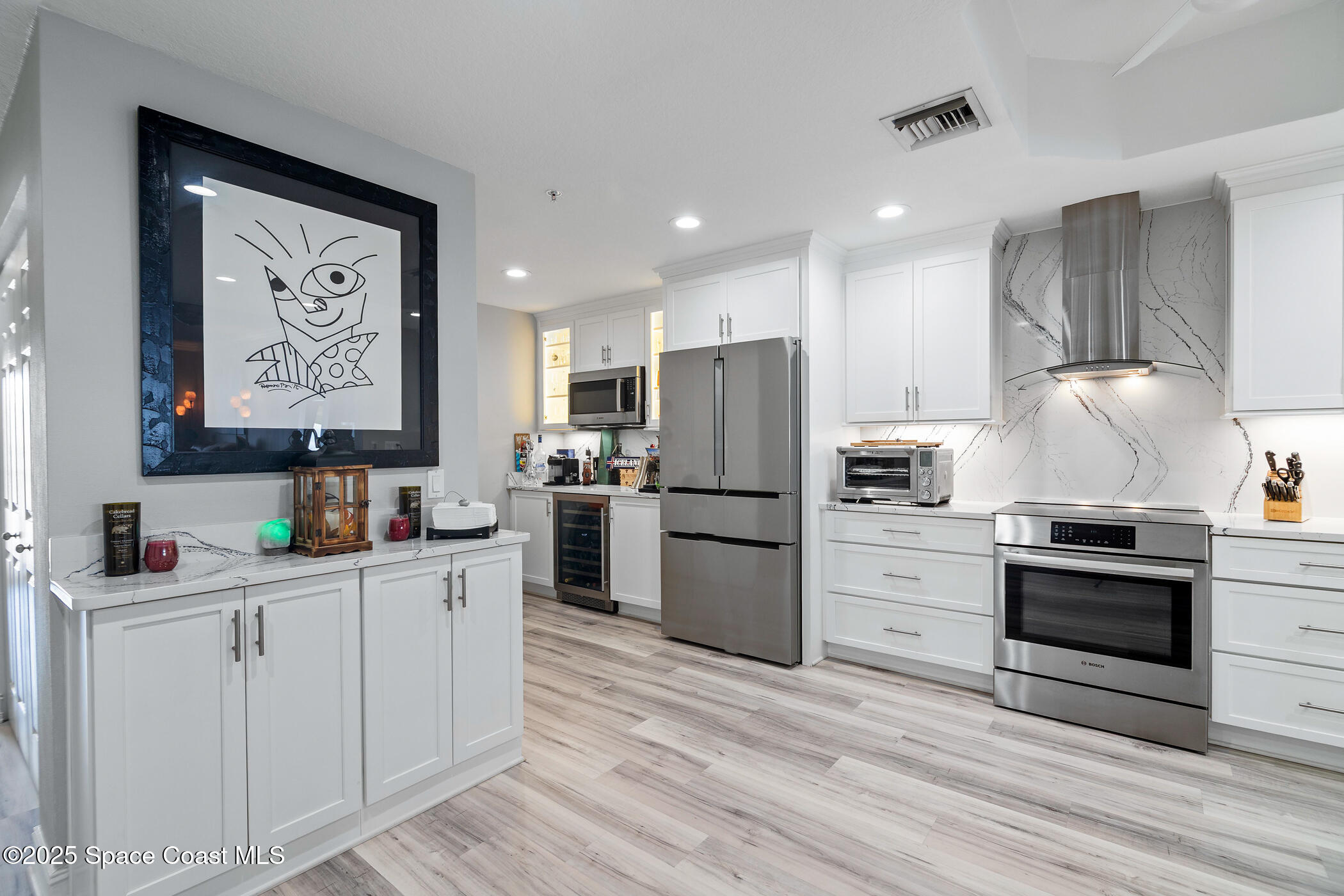 480 Sail Lane, Unit 703 Merritt Island, FL 32953 - Photo 5 of 41 a kitchen with a refrigerator and a stove top oven