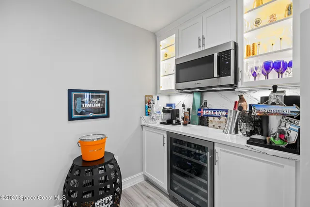 a kitchen with white cabinets and sink