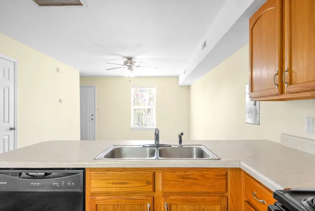 a kitchen with stainless steel appliances granite countertop a sink stove and cabinets
