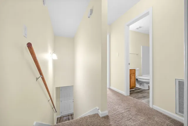 a view of a hallway with furniture and entryway