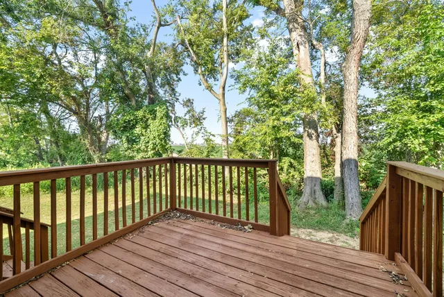 a view of balcony with wooden floor and fence