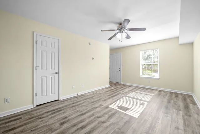 wooden floor in an empty room with a window
