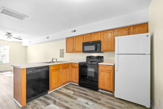 a kitchen with stainless steel appliances granite countertop a refrigerator stove a sink and dishwasher