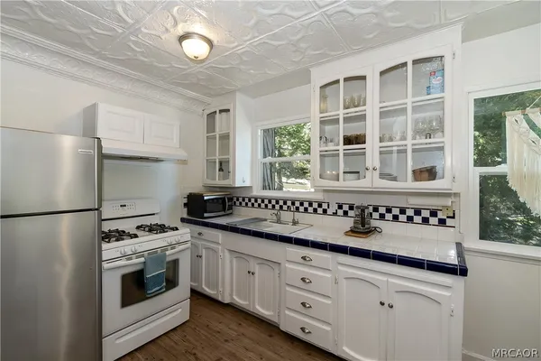 a kitchen with granite countertop a sink and a stove