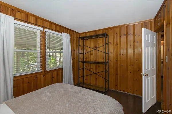 a bedroom with a bed and a chair