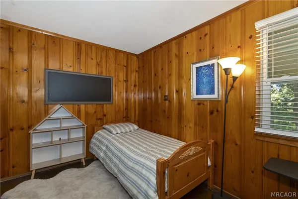 a bedroom with a bed and a dresser