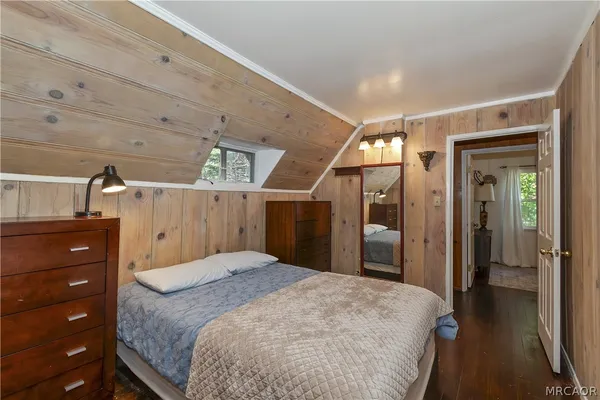 a bedroom with a large bed and a window