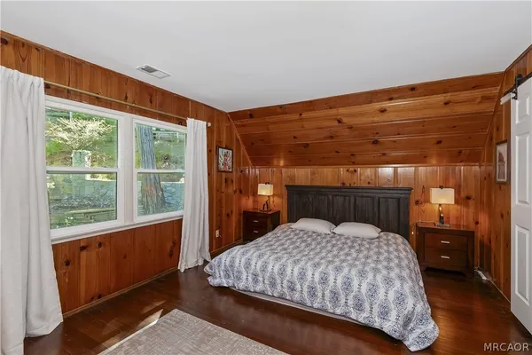 a bedroom with a bed and a dresser