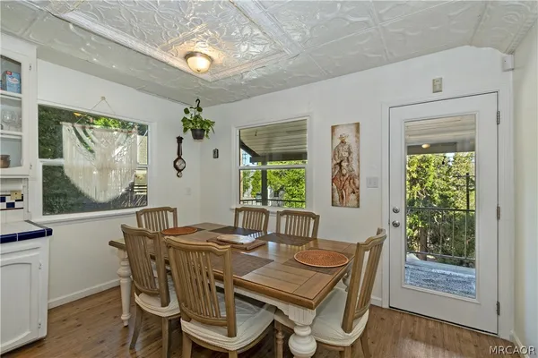 a kitchen with a table chairs refrigerator and stove