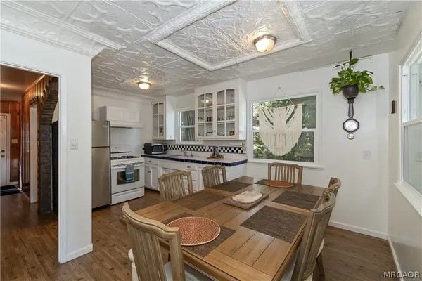a kitchen with granite countertop a white stove top oven and refrigerator