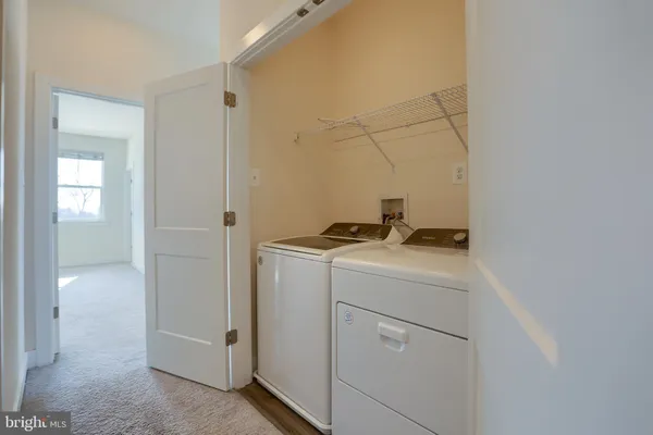 a view of storage and utility room with washer and dryer
